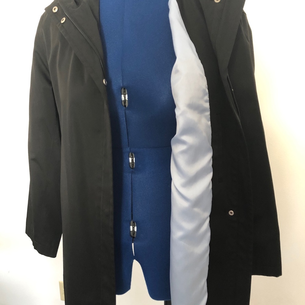 Black hooded raincoat with baby blue satin lining.